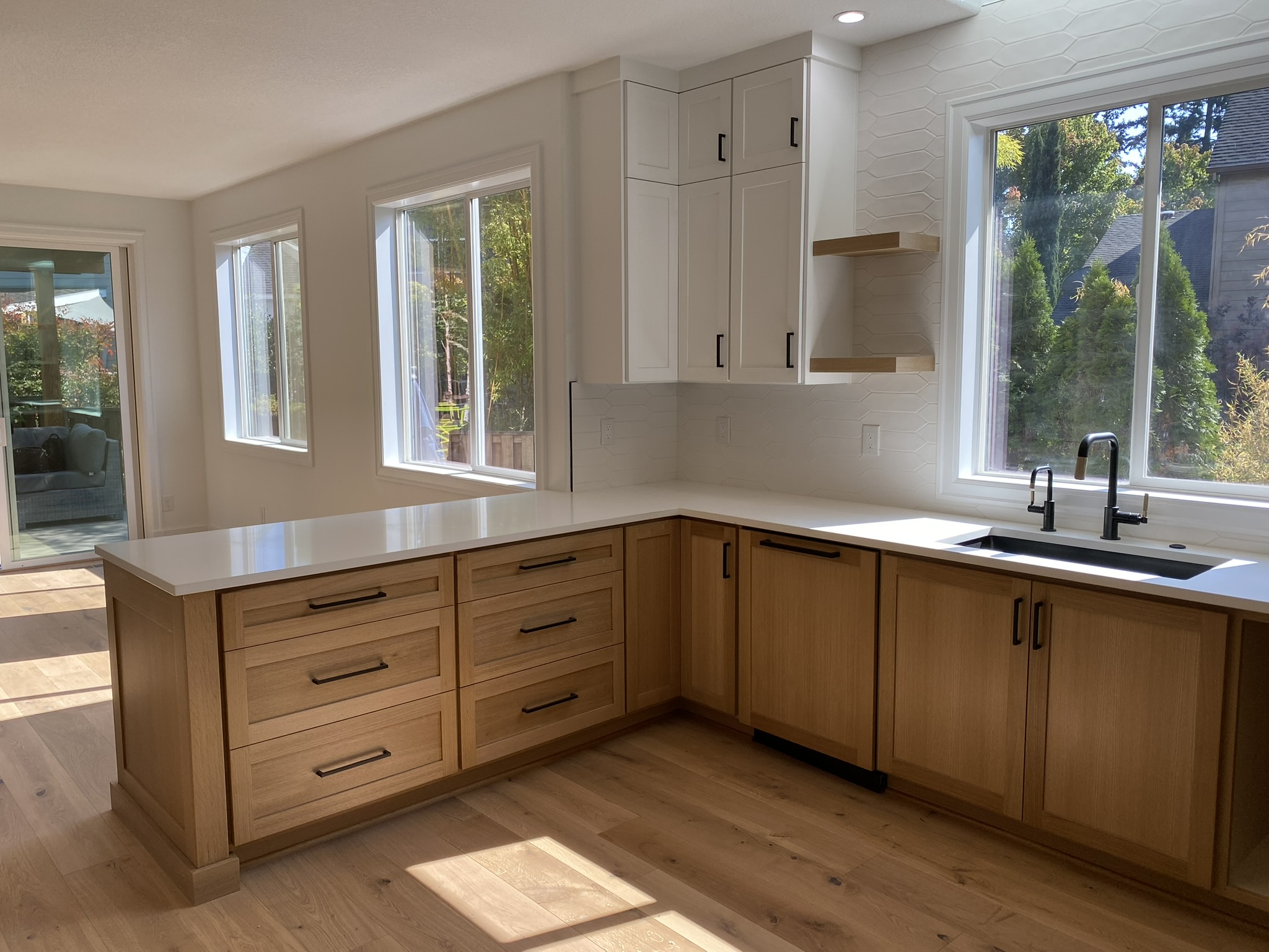 Bright white kitchen with natural oak island and warm wood accents throughout