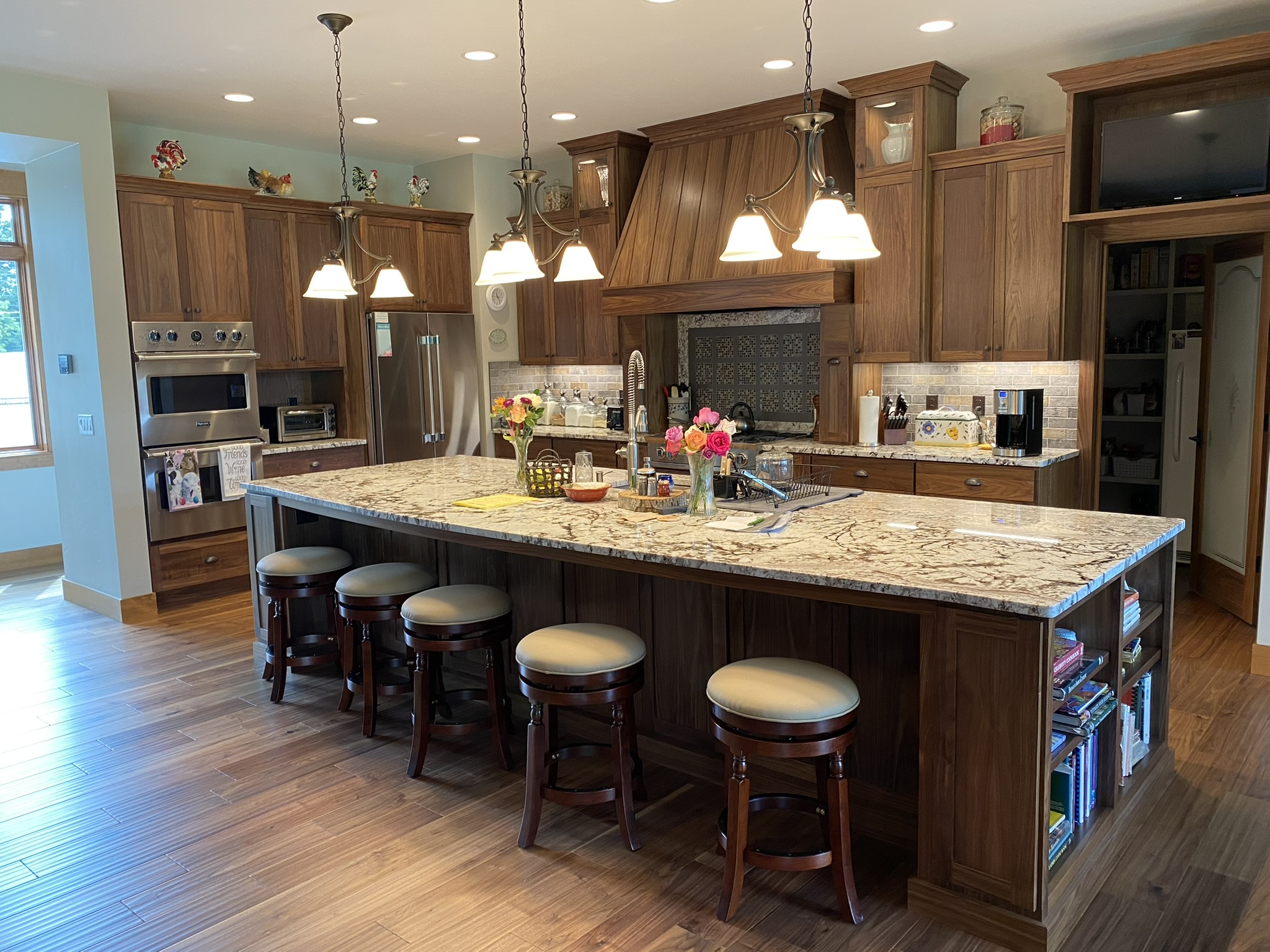 Traditional kitchen with stained wood cabinetry and custom decorative range hood