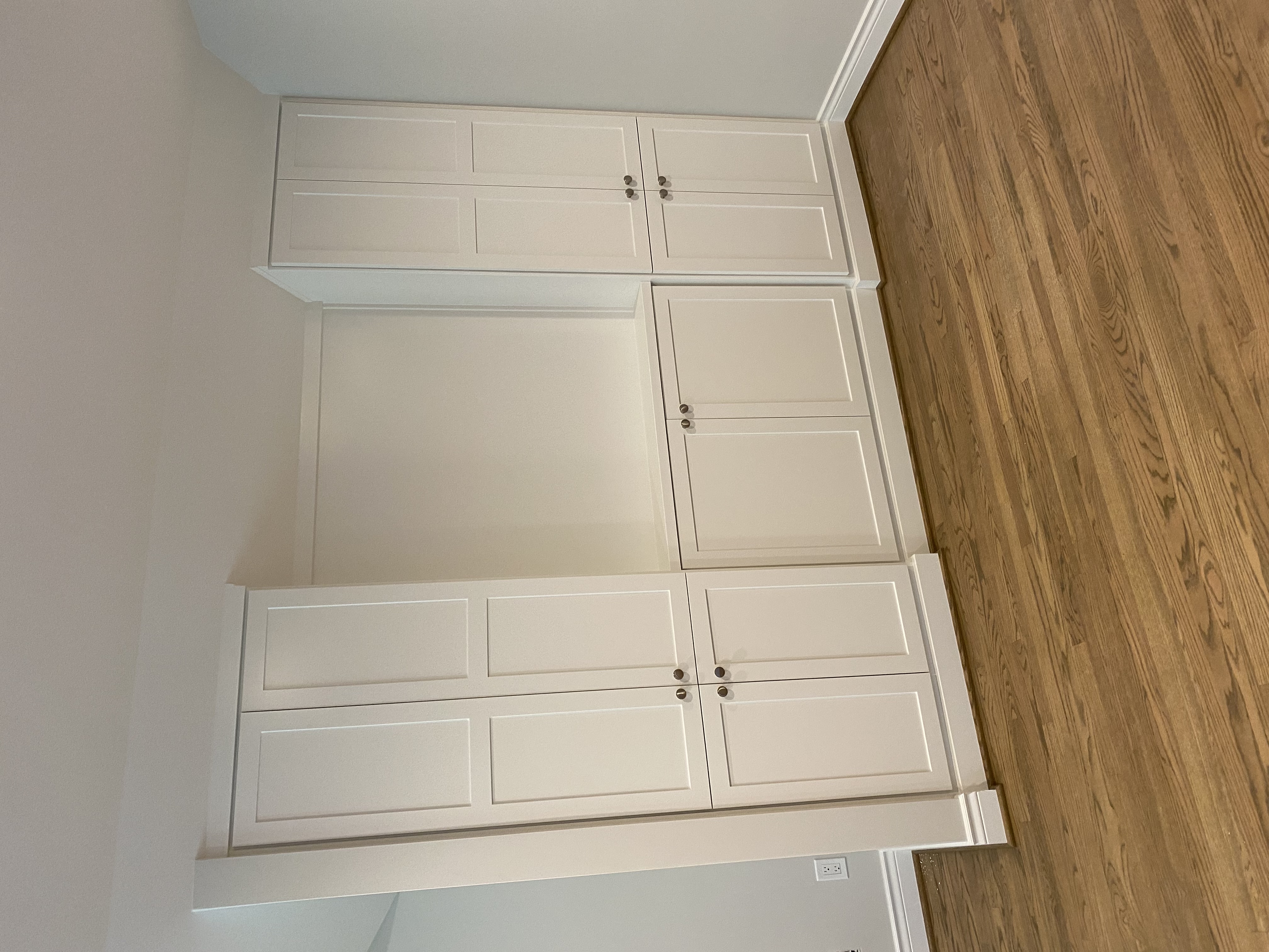 Top-down view of the white shaker built-in cabinetry showing the concealed door panel detail