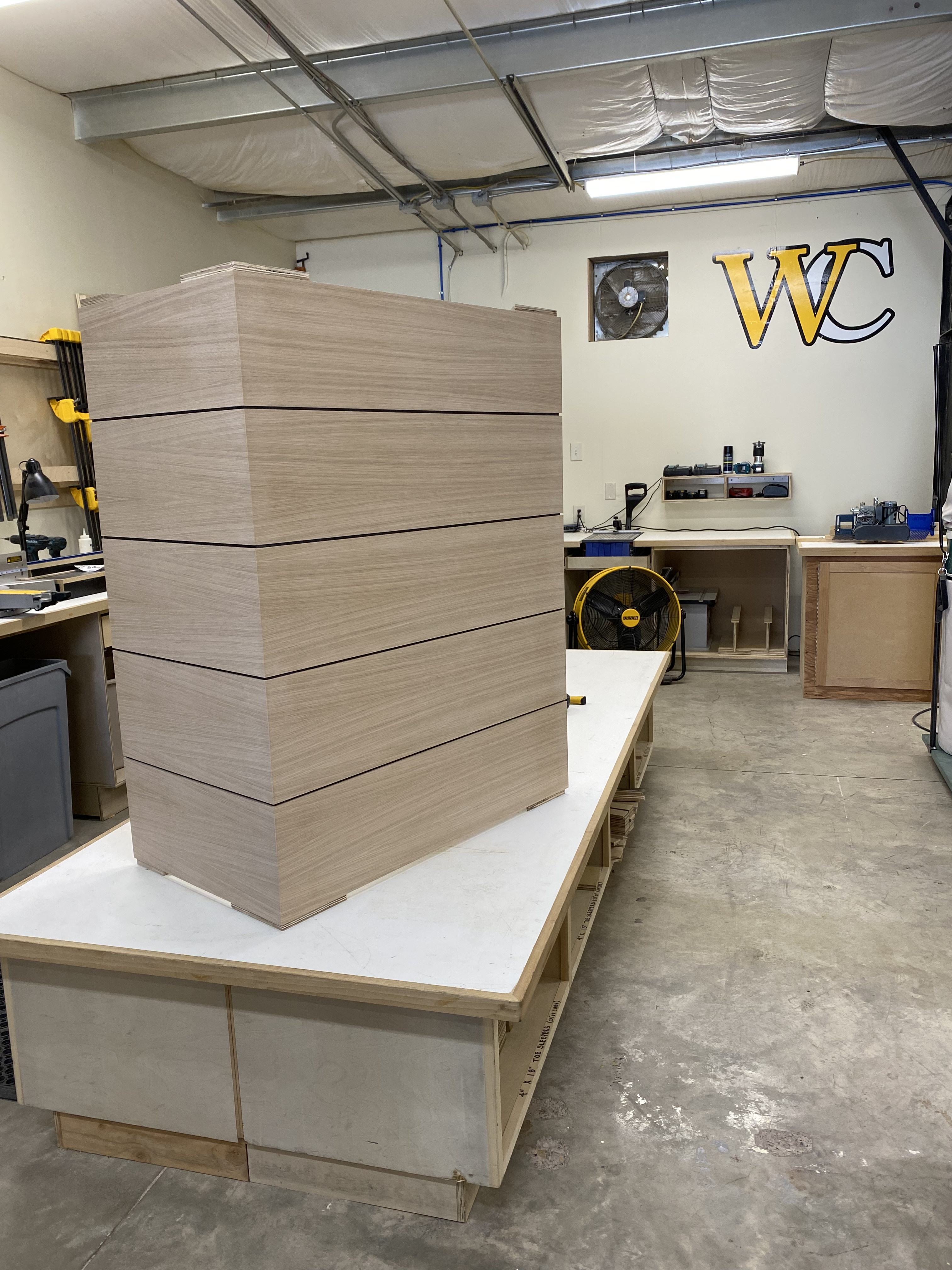 Wood grain slab-front cabinet doors laid out in the shop during fabrication